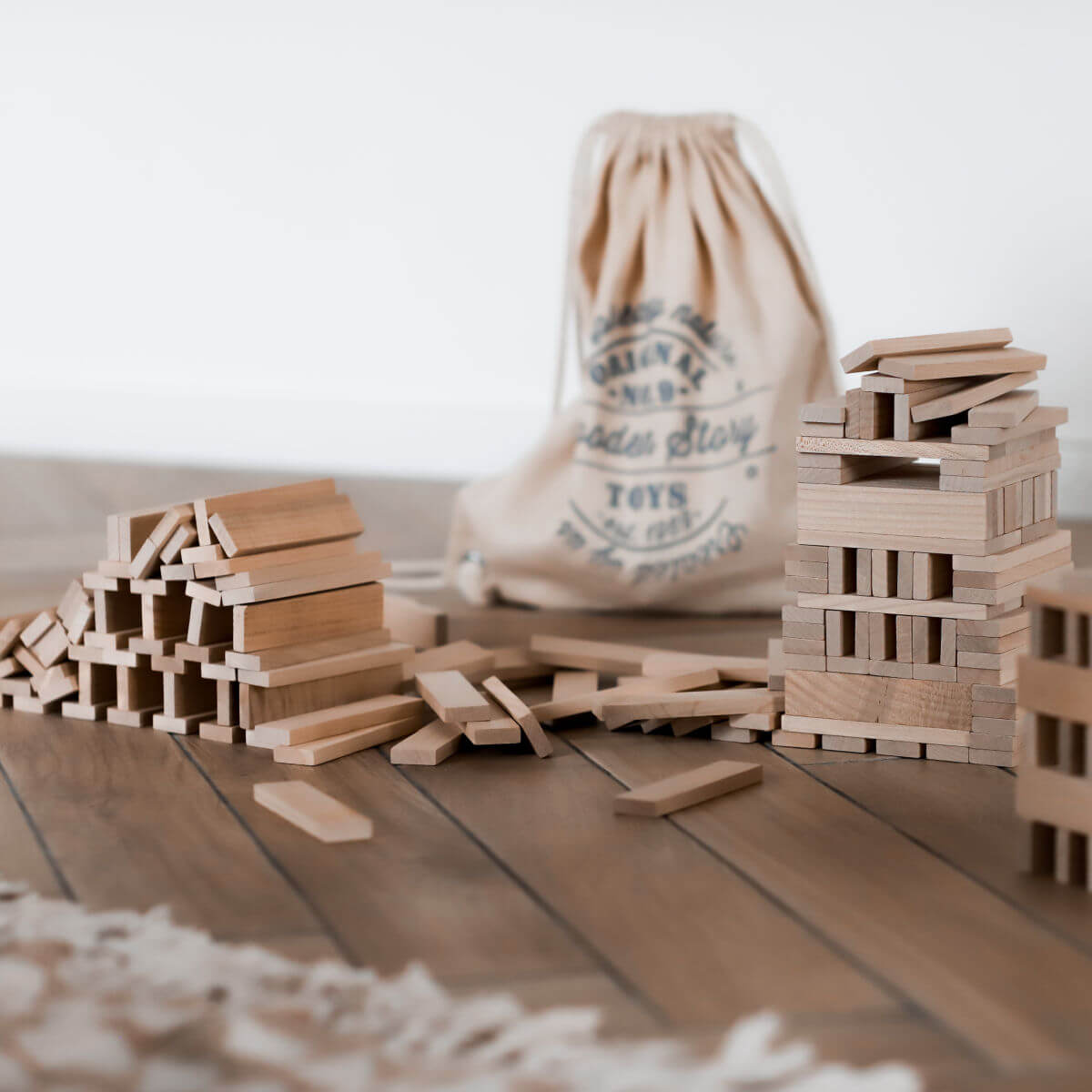 architectural wooden building blocks with cotton sack by wooden story