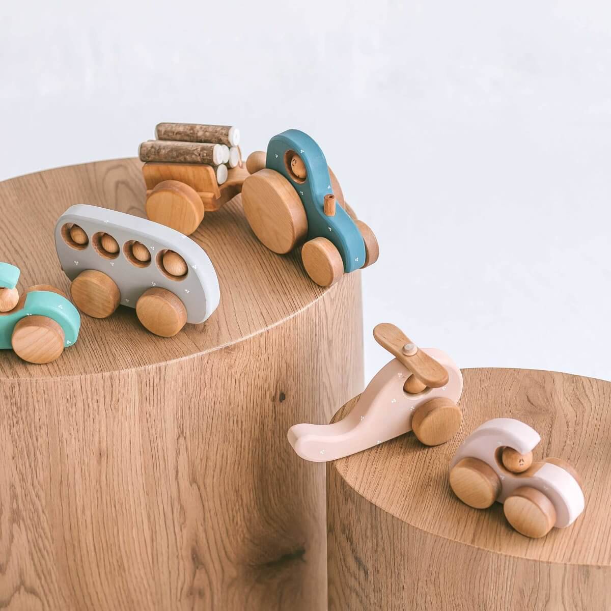 Wooden tractor and trailer alongside other handmade eco toys by Friendly Toys