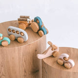 Wooden tractor and trailer alongside other handmade eco toys by Friendly Toys