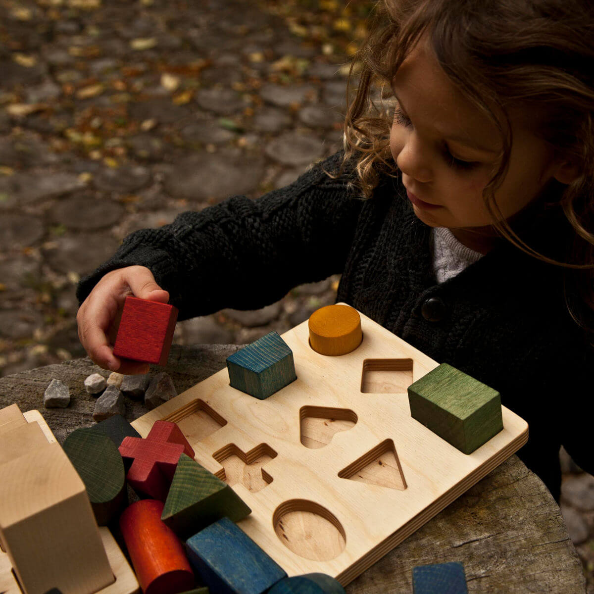 Montessori shape sorting puzzle board in rainbow colours by wooden story