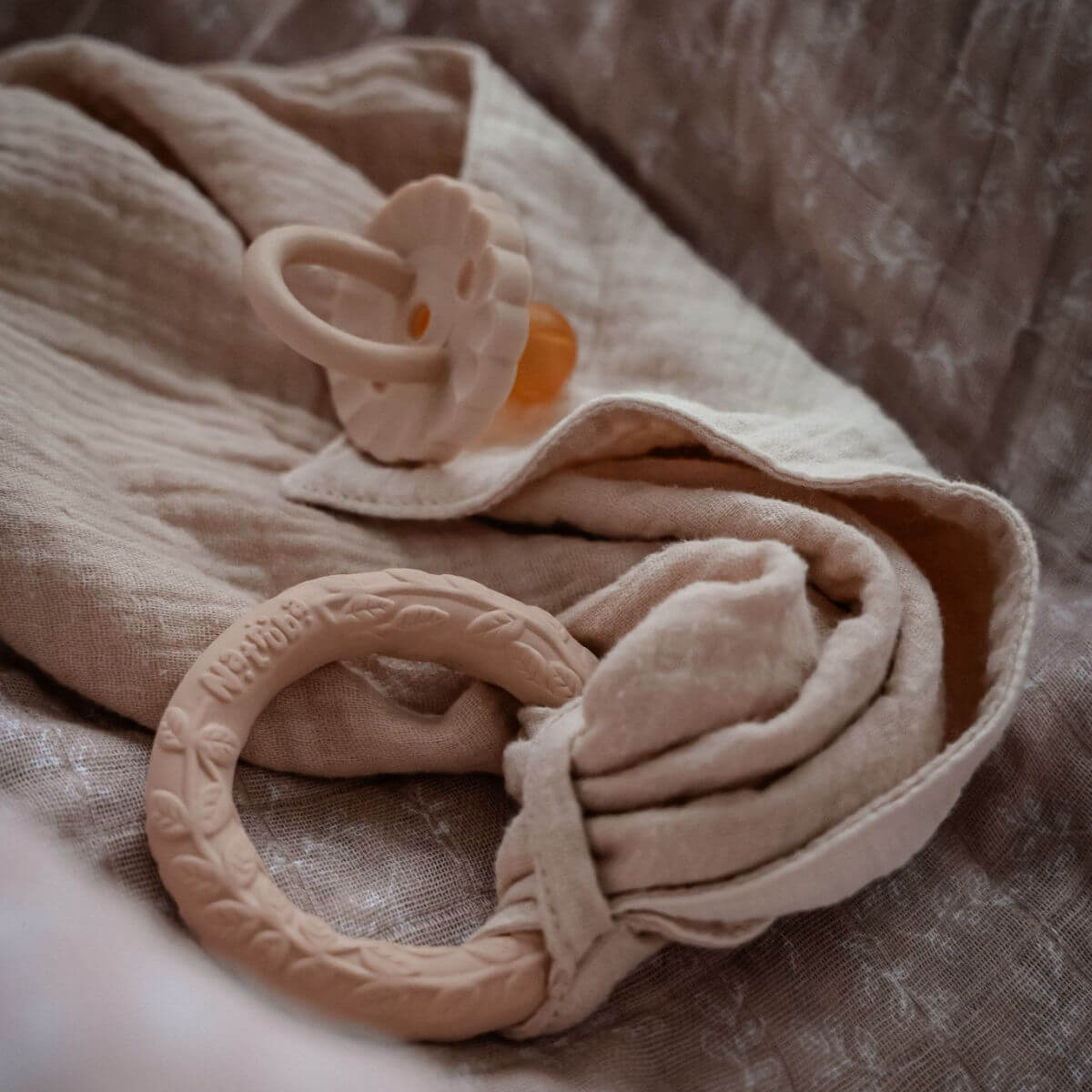 natruba organic cotton comforter and natural rubber teething ring in creme