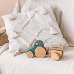 Montessori-style wooden tractor toy in toddler play scene