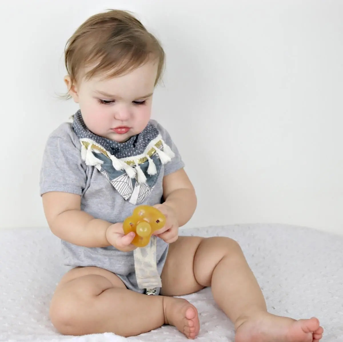 Organic dummy | pacifier | soother Clip in soft grey pom poms design at blue brontide uk