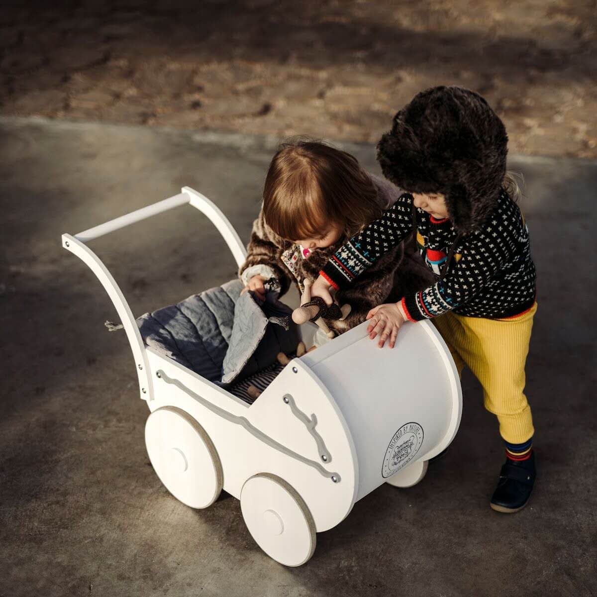 wooden dolls in pram