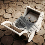 Toy wooden dolls in pram