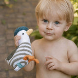 little boy playing outside with seagull baby rattle