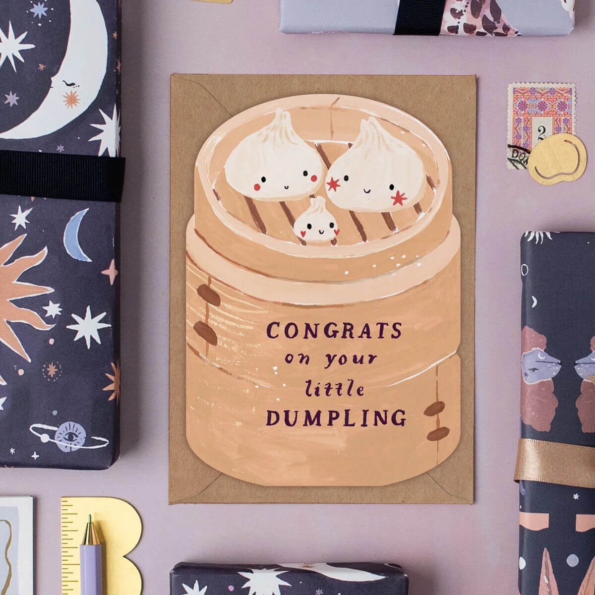 Card with dumpling illustration and 'Congrats on your little dumpling' text on a decorative background.