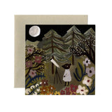 A square art print or card featuring a whimsical folk-art style illustration of a child in a white dress looking through a telescope at a night sky, with trees, flowers, and a full moon. The print is shown in front of a kraft paper envelope against a plain white background.
