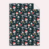 Patterned gift wrapping paper with colourful mushrooms on a dark background illustrated by sister paper co