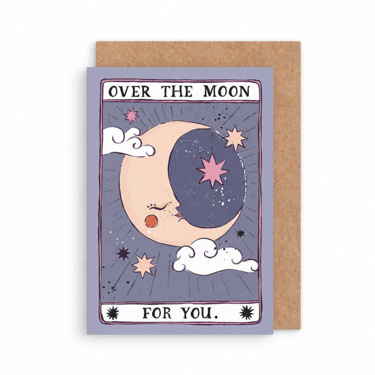A tarot-style greeting card with a kraft envelope behind it. The card illustration shows a crescent moon and stars with the text 'OVER THE MOON FOR YOU illustrated by sister paper co.