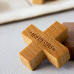 Wooden tic tac toe game piece with 'Wooden Story' branding on a light background