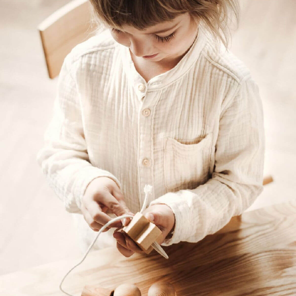 wooden needle threading toy by wooden story