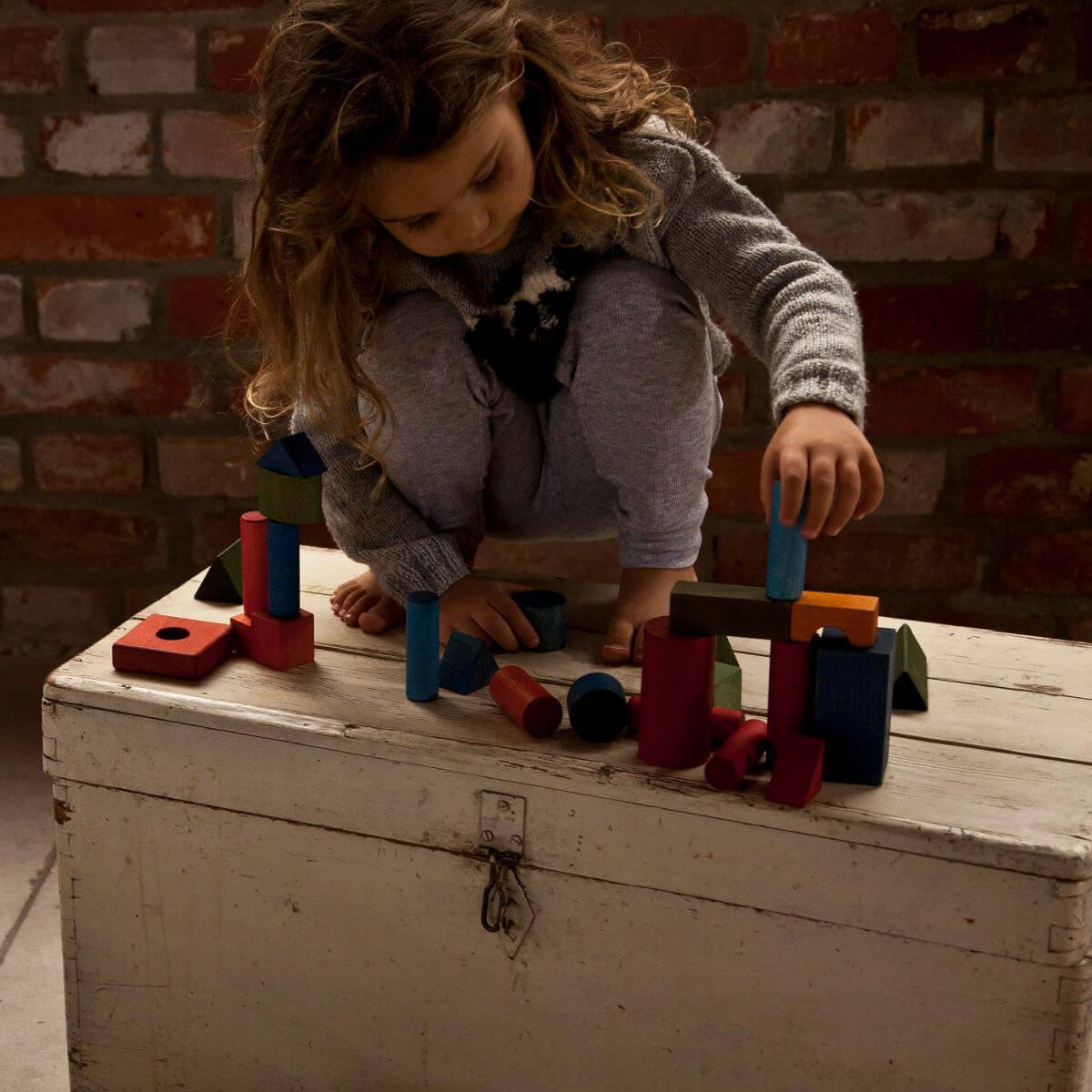 wooden blocks in tray in rainbow colours by wooden story